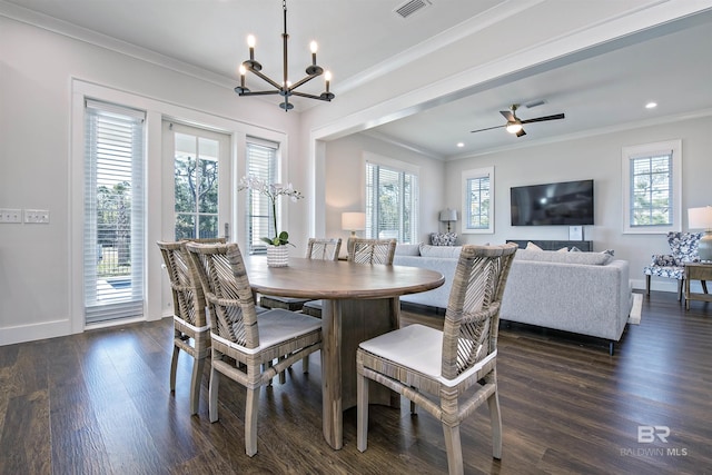 dining area with dark wood-type flooring, crown molding, and ceiling fan with notable chandelier