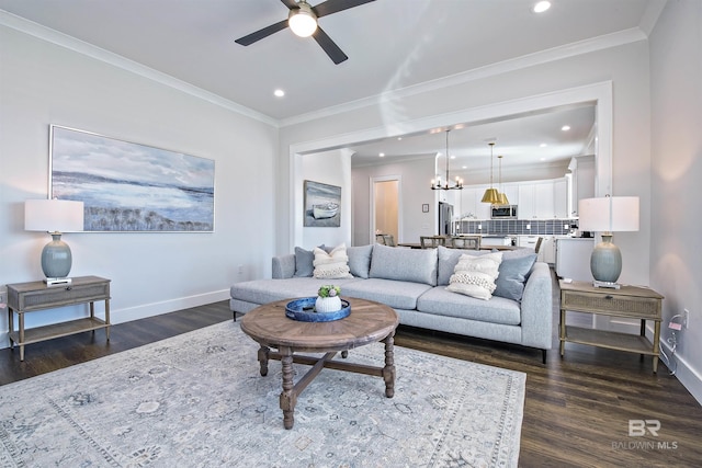 living room featuring crown molding, ceiling fan with notable chandelier, and dark hardwood / wood-style flooring