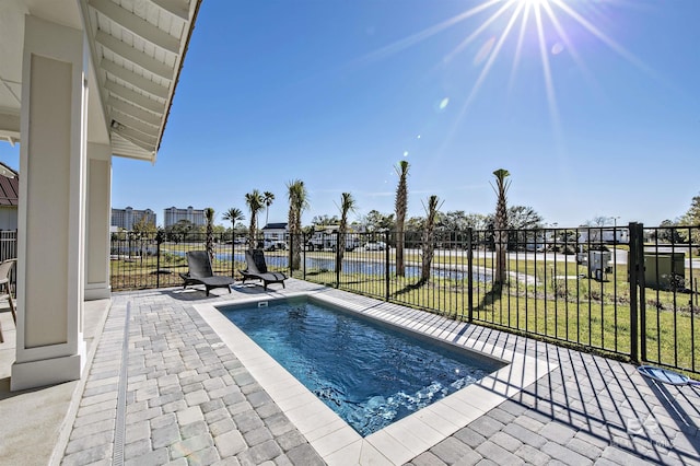 view of swimming pool featuring a patio and a yard