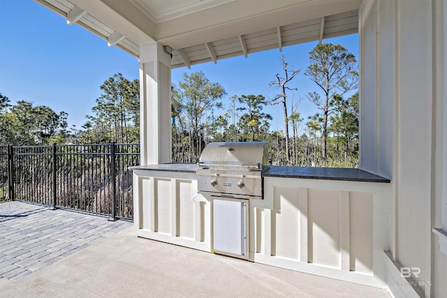 view of patio featuring area for grilling and a grill