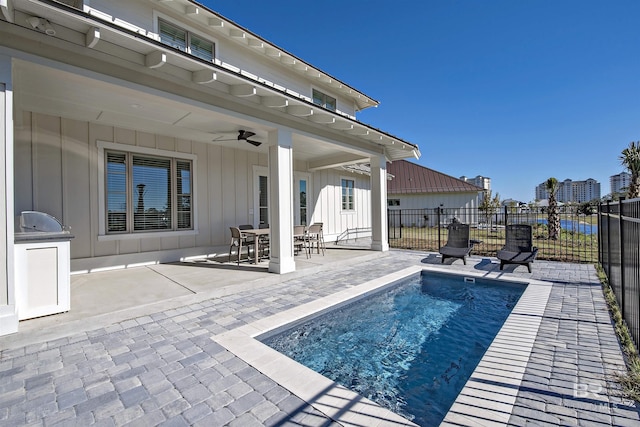 view of pool with ceiling fan and a patio