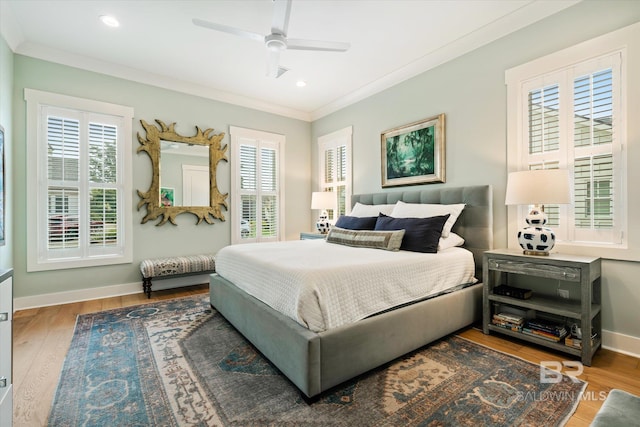 bedroom featuring ceiling fan, ornamental molding, and hardwood / wood-style floors