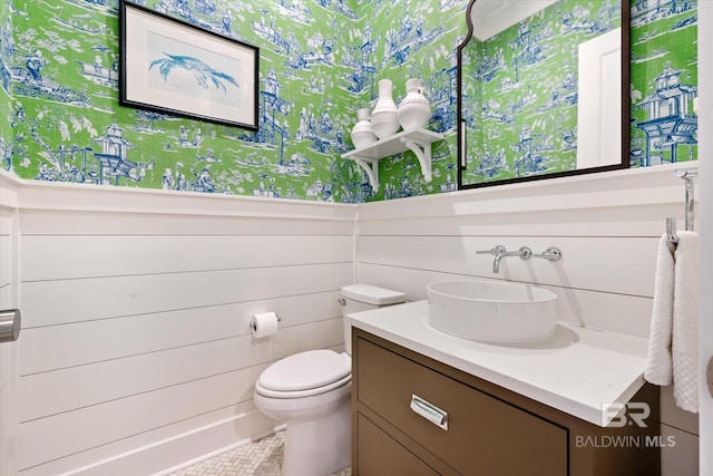 bathroom featuring toilet and vanity with extensive cabinet space