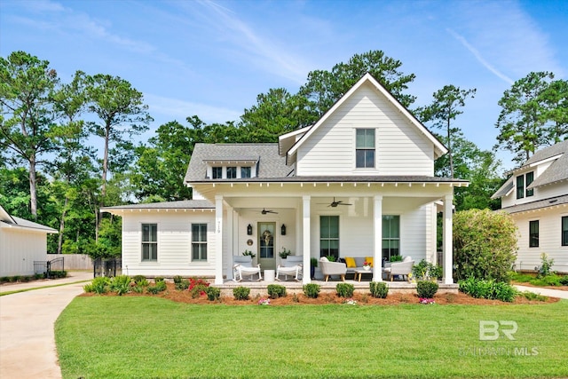 modern farmhouse with ceiling fan, a front lawn, and outdoor lounge area