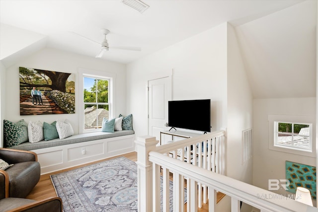 interior space with ceiling fan, lofted ceiling, and wood-type flooring