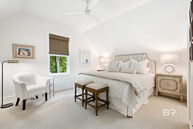 carpeted bedroom with ceiling fan and vaulted ceiling