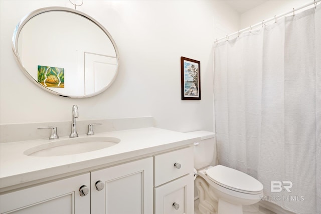 bathroom with toilet and large vanity