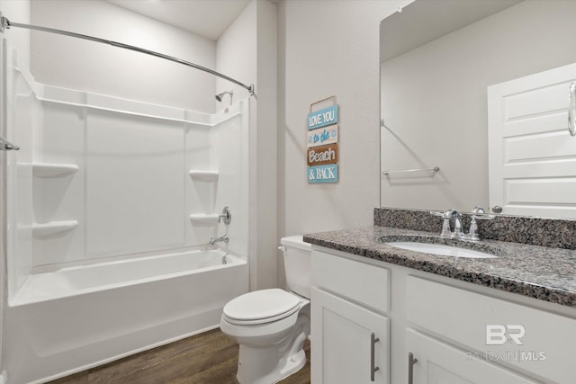 full bathroom featuring toilet, tub / shower combination, wood finished floors, and vanity