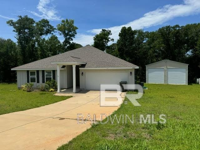 32807 N Pickens Ave, Lillian, AL 36549 - ranch-style house featuring a front yard, a shingled roof, and driveway