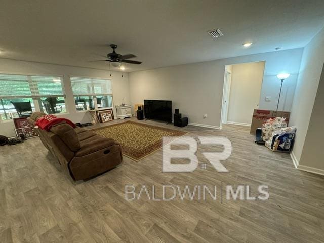 32807 N Pickens Ave, Lillian, AL 36549 - living room featuring plenty of natural light, wood finished floors, ceiling fan, and baseboards