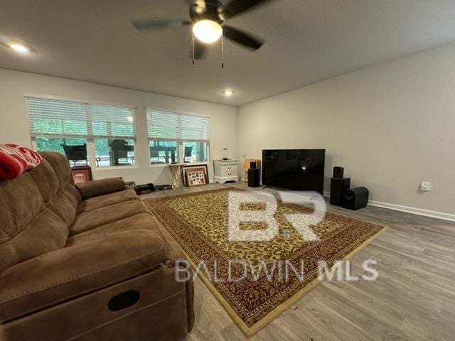 32807 N Pickens Ave, Lillian, AL 36549 - living area with ceiling fan, wood finished floors, and baseboards