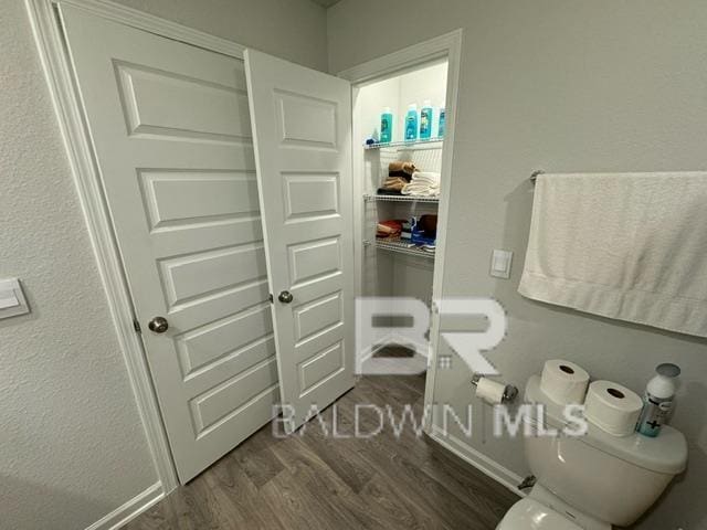 32807 N Pickens Ave, Lillian, AL 36549 - bathroom featuring wood finished floors and toilet