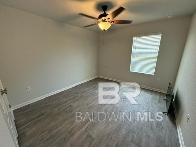 32807 N Pickens Ave, Lillian, AL 36549 - unfurnished room with a ceiling fan, dark wood-style floors, and baseboards