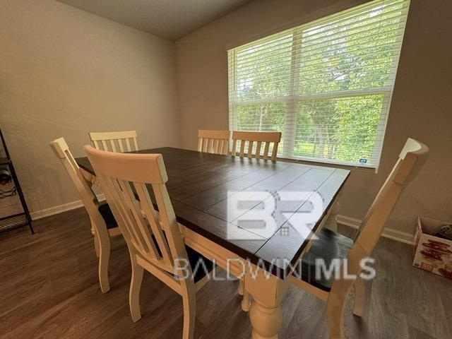 32807 N Pickens Ave, Lillian, AL 36549 - dining room featuring plenty of natural light, wood finished floors, and baseboards