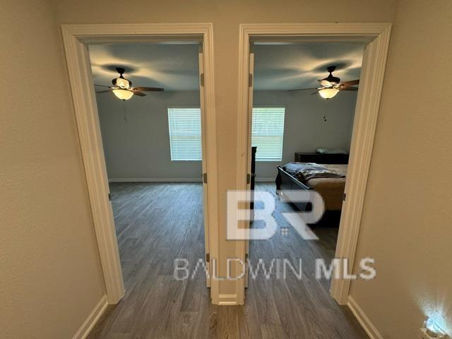 32807 N Pickens Ave, Lillian, AL 36549 - hallway featuring dark wood-style floors and baseboards
