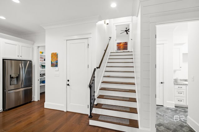 stairway featuring crown molding, hardwood / wood-style flooring, and ceiling fan