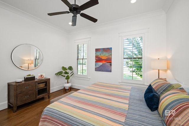 bedroom featuring dark wood-type flooring, ceiling fan, and crown molding