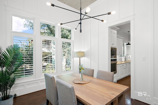 dining room featuring high vaulted ceiling, plenty of natural light, and dark hardwood / wood-style floors