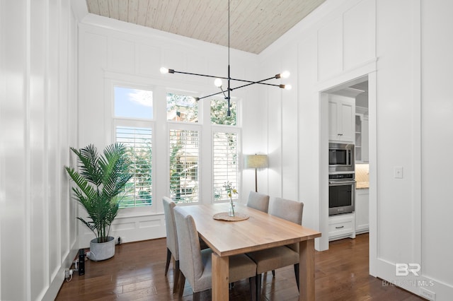 dining area featuring dark wood-type flooring and a notable chandelier