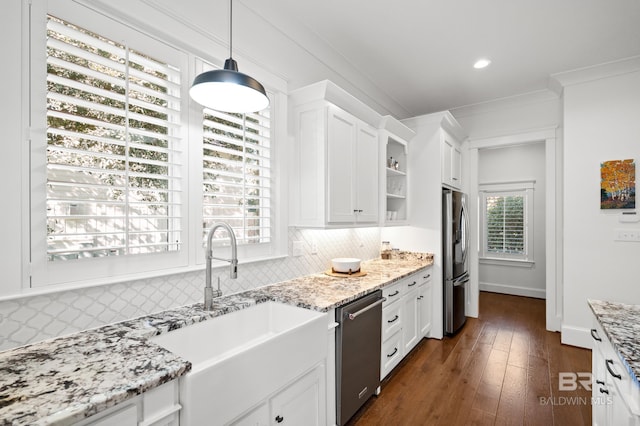 kitchen with white cabinetry, stainless steel appliances, plenty of natural light, and backsplash