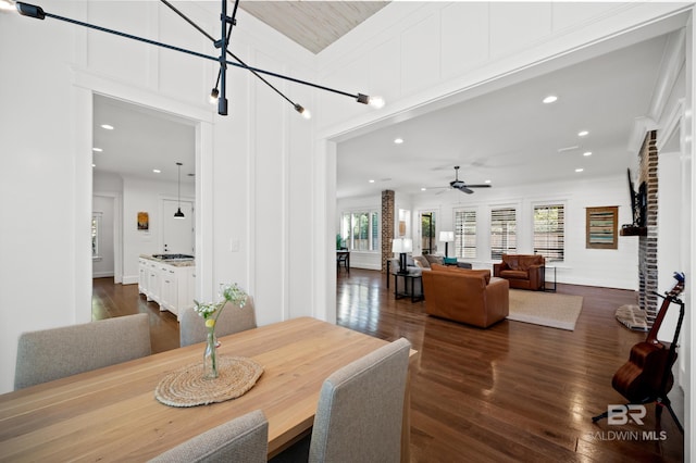 dining room with ceiling fan and dark hardwood / wood-style flooring