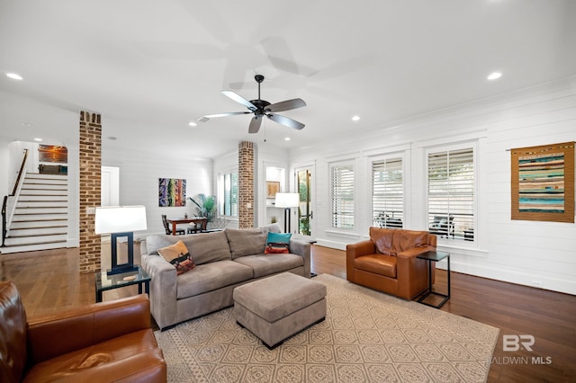 living room with light hardwood / wood-style flooring and ceiling fan