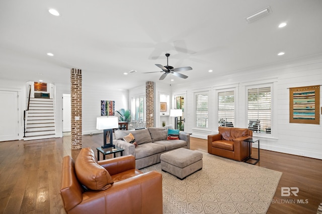 living room with crown molding, light hardwood / wood-style flooring, and ceiling fan