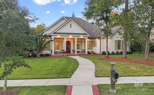 view of front facade with covered porch and a front lawn