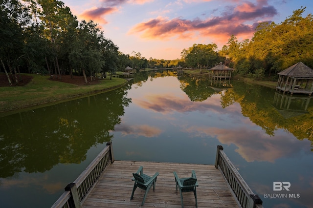 view of dock featuring a gazebo and a water view