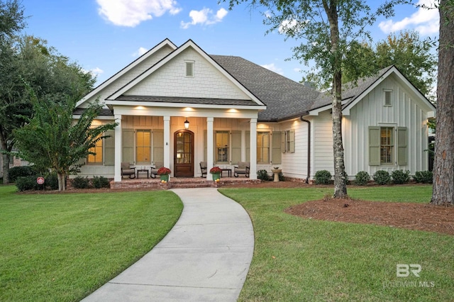 view of front facade with covered porch and a front lawn