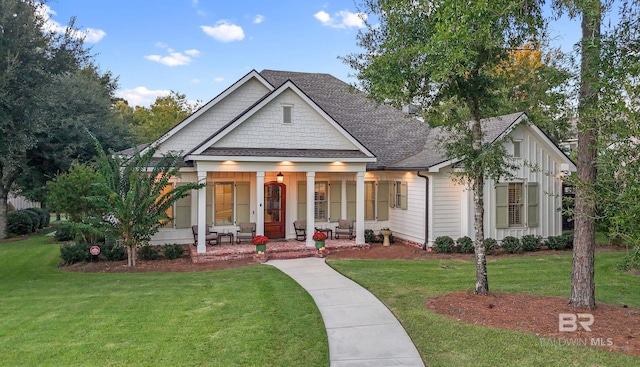 view of front of home with covered porch and a front yard