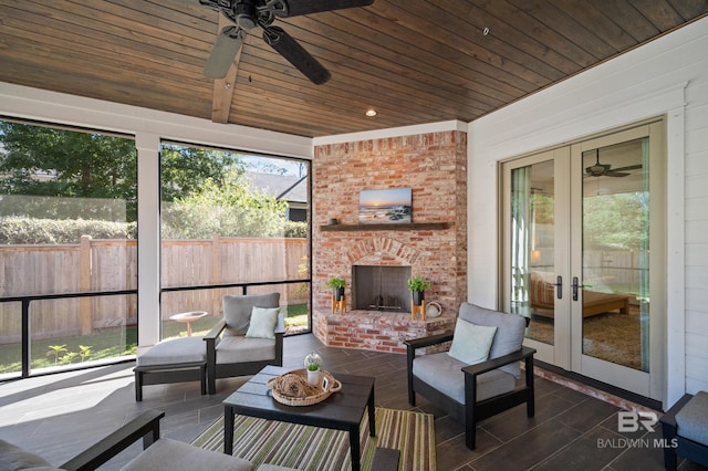 sunroom / solarium featuring french doors, wood ceiling, and ceiling fan