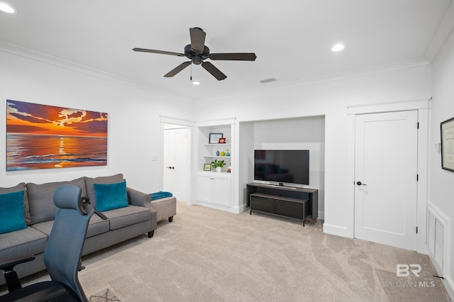 carpeted living room with crown molding and ceiling fan