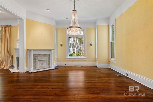 251 S Georgia Ave, Mobile, AL 36604 - unfurnished living room with wood-type flooring, a fireplace, visible vents, and an inviting chandelier