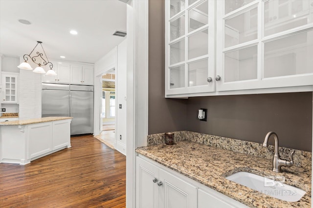 251 S Georgia Ave, Mobile, AL 36604 - kitchen with built in fridge, a sink, glass insert cabinets, white cabinets, and dark wood-style floors