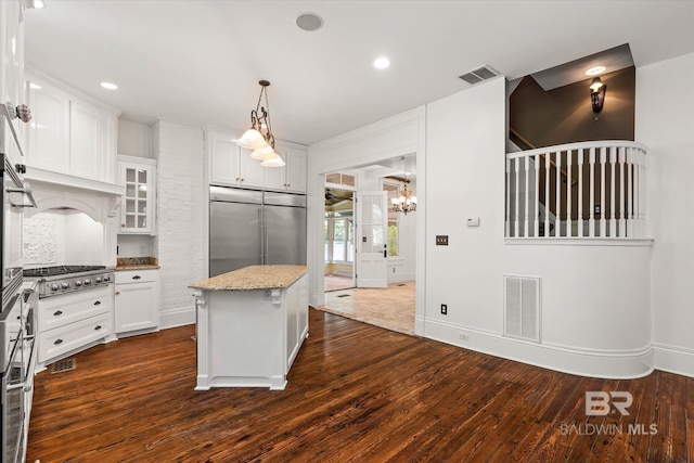 251 S Georgia Ave, Mobile, AL 36604 - kitchen with a center island, dark wood finished floors, appliances with stainless steel finishes, light stone countertops, and visible vents