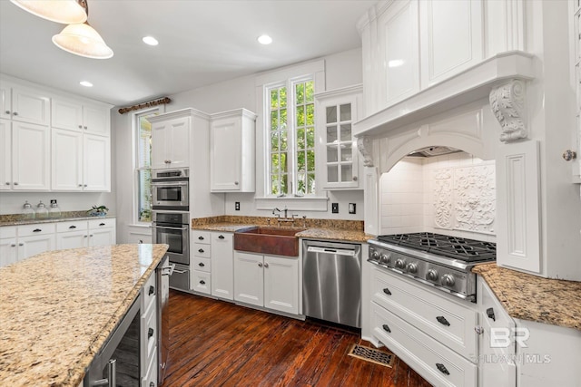 251 S Georgia Ave, Mobile, AL 36604 - kitchen with tasteful backsplash, a sink, white cabinetry, dark wood finished floors, and appliances with stainless steel finishes
