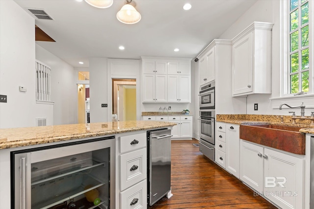 251 S Georgia Ave, Mobile, AL 36604 - kitchen featuring white cabinets, beverage cooler, dark wood-style floors, visible vents, and a sink