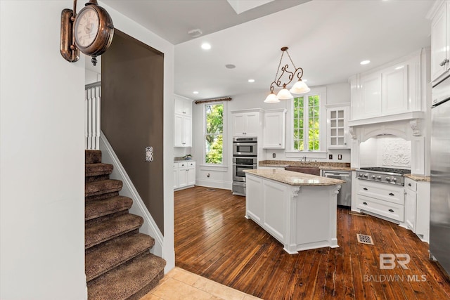 251 S Georgia Ave, Mobile, AL 36604 - kitchen with light stone counters, a sink, white cabinets, stainless steel appliances, and dark wood finished floors