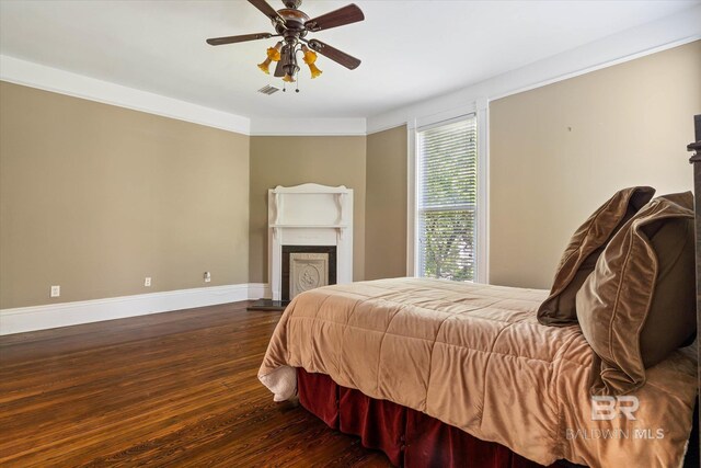 251 S Georgia Ave, Mobile, AL 36604 - bedroom featuring baseboards, wood finished floors, visible vents, and a fireplace