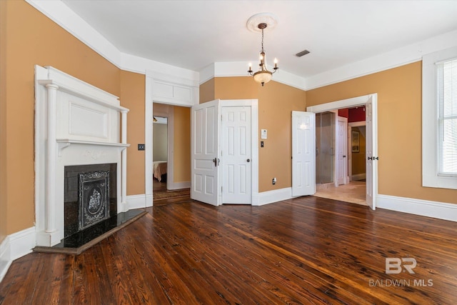 251 S Georgia Ave, Mobile, AL 36604 - unfurnished living room featuring wood finished floors, a chandelier, a fireplace, baseboards, and visible vents