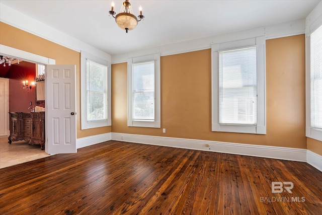 251 S Georgia Ave, Mobile, AL 36604 - spare room featuring hardwood / wood-style floors, baseboards, and a notable chandelier