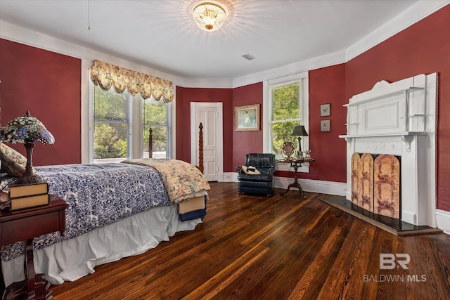 251 S Georgia Ave, Mobile, AL 36604 - bedroom with visible vents, hardwood / wood-style flooring, baseboards, and a fireplace