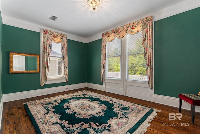 251 S Georgia Ave, Mobile, AL 36604 - spare room with wood finished floors, a healthy amount of sunlight, baseboards, and visible vents