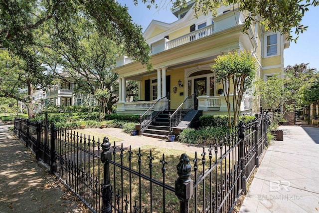 251 S Georgia Ave, Mobile, AL 36604 - victorian home with a fenced front yard, stairs, and covered porch