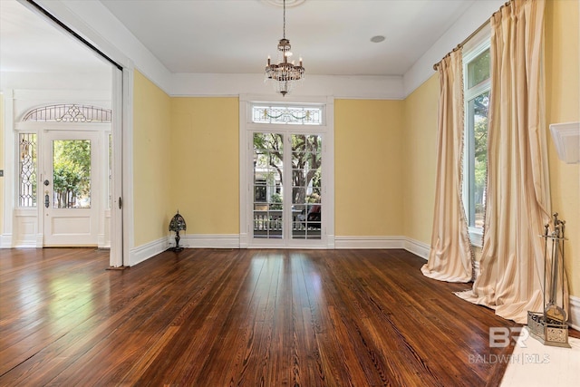 251 S Georgia Ave, Mobile, AL 36604 - unfurnished dining area featuring a chandelier, a wealth of natural light, and dark wood-type flooring