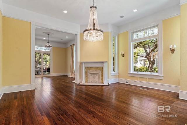 251 S Georgia Ave, Mobile, AL 36604 - unfurnished living room with hardwood / wood-style flooring, baseboards, and a chandelier