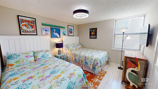 511 E Beach Blvd Unit 503, Gulf Shores, AL 36542 - bedroom featuring a textured ceiling and wood finished floors