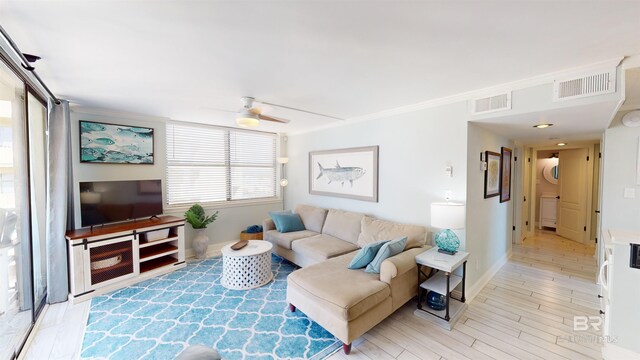 511 E Beach Blvd Unit 503, Gulf Shores, AL 36542 - living room featuring light wood-style flooring, ceiling fan, baseboards, and ornamental molding