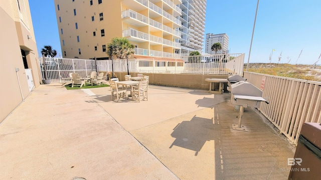 511 E Beach Blvd Unit 503, Gulf Shores, AL 36542 - view of patio with outdoor dining area and fence